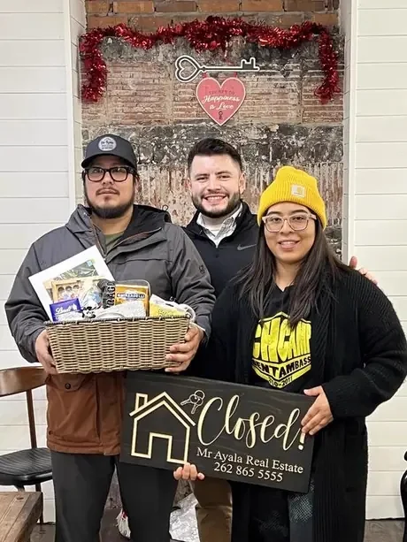 Buyers with their closing gift basket and Closed sign